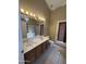 This bathroom features a double vanity, tile flooring, a toilet, and a light above the mirror at 18899 N 77Th Ave, Glendale, AZ 85308