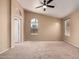 Carpeted bedroom with ceiling fan and two large windows at 18899 N 77Th Ave, Glendale, AZ 85308