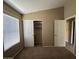 This bedroom features neutral walls, carpet flooring, and a closet with sliding doors at 18899 N 77Th Ave, Glendale, AZ 85308