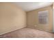 Neutral bedroom featuring tan carpet, window with blinds, and tan walls at 18899 N 77Th Ave, Glendale, AZ 85308