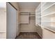 Walk-in closet with built-in shelves and carpet at 18899 N 77Th Ave, Glendale, AZ 85308