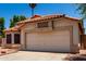 Charming single-story home with desert landscaping, tile roof, and a two-car garage at 18899 N 77Th Ave, Glendale, AZ 85308