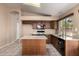 Bright kitchen has granite counters, stainless sink, and island at 18899 N 77Th Ave, Glendale, AZ 85308