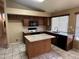 Well-lit kitchen features an island, plenty of cabinets, granite countertops, and tile flooring at 18899 N 77Th Ave, Glendale, AZ 85308
