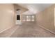 Open living room with high ceiling, carpet, lots of windows, and natural light at 18899 N 77Th Ave, Glendale, AZ 85308