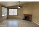 Spacious living room with a fireplace, neutral walls, tile flooring, and bright window at 18899 N 77Th Ave, Glendale, AZ 85308