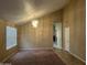 Bright living room with neutral walls, soft carpet, modern light fixture, and archway views at 18899 N 77Th Ave, Glendale, AZ 85308