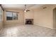 Spacious living room with tile floor and a brick fireplace at 18899 N 77Th Ave, Glendale, AZ 85308