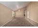Spacious living room featuring neutral walls, carpet, and decorative chandelier at 18899 N 77Th Ave, Glendale, AZ 85308