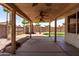 Covered patio with ceiling fans overlooks desert landscaping and block wall at 18899 N 77Th Ave, Glendale, AZ 85308