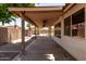 Covered patio with ceiling fans overlooks desert landscaping and block wall at 18899 N 77Th Ave, Glendale, AZ 85308