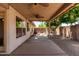 Covered patio with ceiling fans overlooks desert landscaping and block wall at 18899 N 77Th Ave, Glendale, AZ 85308