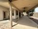 This backyard features a large patio with several ceiling fans and a beige house at 18899 N 77Th Ave, Glendale, AZ 85308