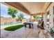 Covered patio area includes a pool table and views of the backyard pool at 2016 S 102Nd Ln, Tolleson, AZ 85353