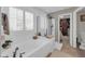 Relaxing bathroom with a soaking tub, glass-enclosed shower, and walk-in closet, providing a spa-like retreat at 2016 S 102Nd Ln, Tolleson, AZ 85353