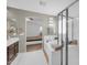 Bright bathroom featuring a soaking tub, glass-enclosed shower, and views to the bedroom providing a luxurious bathing experience at 2016 S 102Nd Ln, Tolleson, AZ 85353