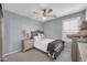 Comfortable bedroom with a ceiling fan, soft gray walls, and neutral-toned furniture at 2016 S 102Nd Ln, Tolleson, AZ 85353