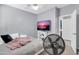 Well-lit bedroom featuring comfortable furnishings, a TV, and a ceiling fan at 2016 S 102Nd Ln, Tolleson, AZ 85353