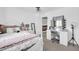 Bright bedroom featuring white furniture, ceiling fan, and vanity with illuminated mirror at 2016 S 102Nd Ln, Tolleson, AZ 85353