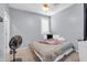 Cozy bedroom with a comfortable bed, window with blinds, and a ceiling fan for added comfort at 2016 S 102Nd Ln, Tolleson, AZ 85353
