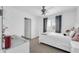 Bright bedroom with white decor, featuring a ceiling fan and large window with shutters at 2016 S 102Nd Ln, Tolleson, AZ 85353