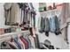 Walk-in closet with ample hanging space, shoe racks, and shelving for organized storage at 2016 S 102Nd Ln, Tolleson, AZ 85353