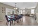 Elegant dining room featuring a large table, French doors, and stylish decor at 2016 S 102Nd Ln, Tolleson, AZ 85353