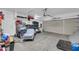 Spacious two-car garage with ample storage space and a variety of household items at 2016 S 102Nd Ln, Tolleson, AZ 85353