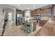 Kitchen with dark cabinetry and a kitchen island provides seating and extra workspace, ideal for cooking and gathering at 2016 S 102Nd Ln, Tolleson, AZ 85353