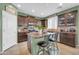 Well-appointed kitchen with dark cabinetry, a kitchen island, and stainless steel appliances offers a functional and stylish cooking space at 2016 S 102Nd Ln, Tolleson, AZ 85353