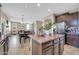 Spacious kitchen island with granite countertops provides extra workspace, seamlessly connecting to the dining area for easy entertaining at 2016 S 102Nd Ln, Tolleson, AZ 85353
