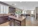 Beautiful kitchen island features granite countertops and dark wood cabinetry, perfect for food preparation and casual dining at 2016 S 102Nd Ln, Tolleson, AZ 85353