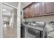 Well-equipped laundry room with modern appliances and ample cabinet space for storage at 2016 S 102Nd Ln, Tolleson, AZ 85353