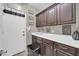 Functional laundry area with cabinets, folding space, and convenient access to the outdoors at 2016 S 102Nd Ln, Tolleson, AZ 85353