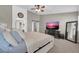 Spacious main bedroom suite with a ceiling fan, en-suite bathroom, and a TV, for ultimate comfort and relaxation at 2016 S 102Nd Ln, Tolleson, AZ 85353