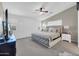 A large bedroom offers a comfortable space with a ceiling fan, plantation shutters and carpet floors at 2016 S 102Nd Ln, Tolleson, AZ 85353