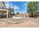 Backyard pool area featuring a basketball hoop, rock accents, and low-maintenance landscaping at 2016 S 102Nd Ln, Tolleson, AZ 85353