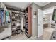 Organized walk-in closet with shelving and hanging rods, perfect for storing clothing and accessories at 2016 S 102Nd Ln, Tolleson, AZ 85353