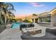 Outdoor living is enhanced by a custom fire pit, seating, and a sparkling swimming pool at 2094 E Aris Dr, Gilbert, AZ 85298
