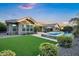 Sprawling backyard includes well-maintained lawn, lush landscape, and a sparkling swimming pool at 2094 E Aris Dr, Gilbert, AZ 85298