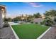 A lush lawn offers a refreshing contrast to the stone-lined landscape, providing a serene setting at 2094 E Aris Dr, Gilbert, AZ 85298