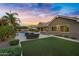 Expansive backyard features a pool, patio, outdoor kitchen, and lush artificial turf at 2094 E Aris Dr, Gilbert, AZ 85298
