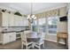 Breakfast nook with a wooden round table, four chairs, and windows with stylish valances at 2094 E Aris Dr, Gilbert, AZ 85298