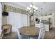 Breakfast nook featuring a wood table, four chairs, stylish light fixture, and natural light from large windows at 2094 E Aris Dr, Gilbert, AZ 85298
