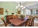 Elegant dining room featuring a stylish chandelier, spacious table, and a view into the living room at 2094 E Aris Dr, Gilbert, AZ 85298