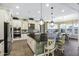 Open kitchen with large island, stainless steel appliances, custom cabinets, and adjoining breakfast nook at 2094 E Aris Dr, Gilbert, AZ 85298