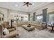 Expansive living room features a large sectional sofa, neutral tones, and seamless access to the kitchen at 2094 E Aris Dr, Gilbert, AZ 85298