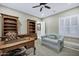 Comfortable home office with custom built-ins, a sofa, and natural light, creating an ideal workspace at 2094 E Aris Dr, Gilbert, AZ 85298