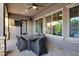 Covered patio with a ceiling fan, dining table with seating, and outdoor access at 2094 E Aris Dr, Gilbert, AZ 85298