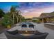Luxurious outdoor space with a fire pit and cozy seating around pool with water features at 2094 E Aris Dr, Gilbert, AZ 85298